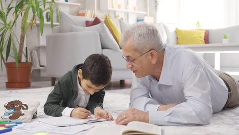 The-father-is-tutoring-his-son-and-helping-him-with-his-lessons.,